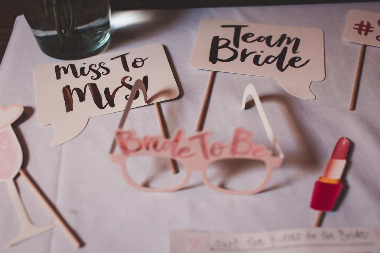 services-01 Flat lay of bridal shower decorations with creative signs and props.
